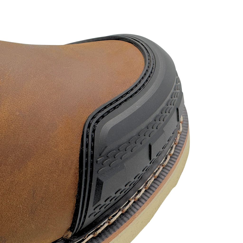 Close-up detail of work boot toe cap showing rubber guard and textured sole construction