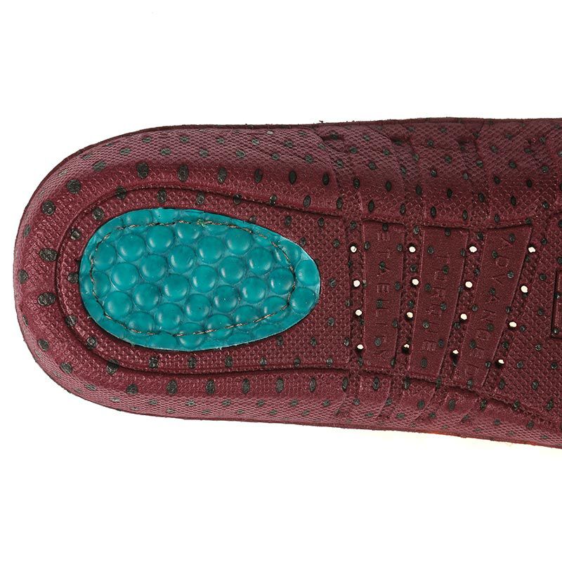 Close-up detail of burgundy shoe footbed with teal gel heel cushion and arch support