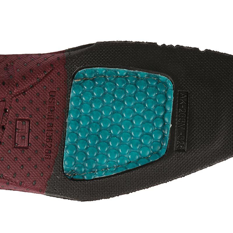 Close-up of Ariat ATS wide square footbed outsole showing teal gel cushion insert and tread pattern