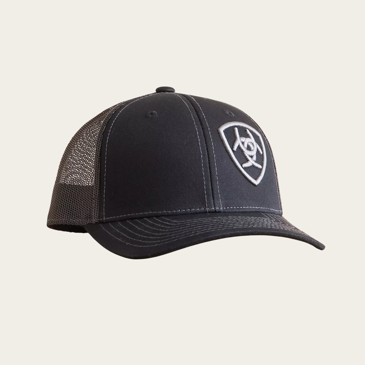 Black Ariat youth trucker cap with mesh back and embroidered shield logo on front panel