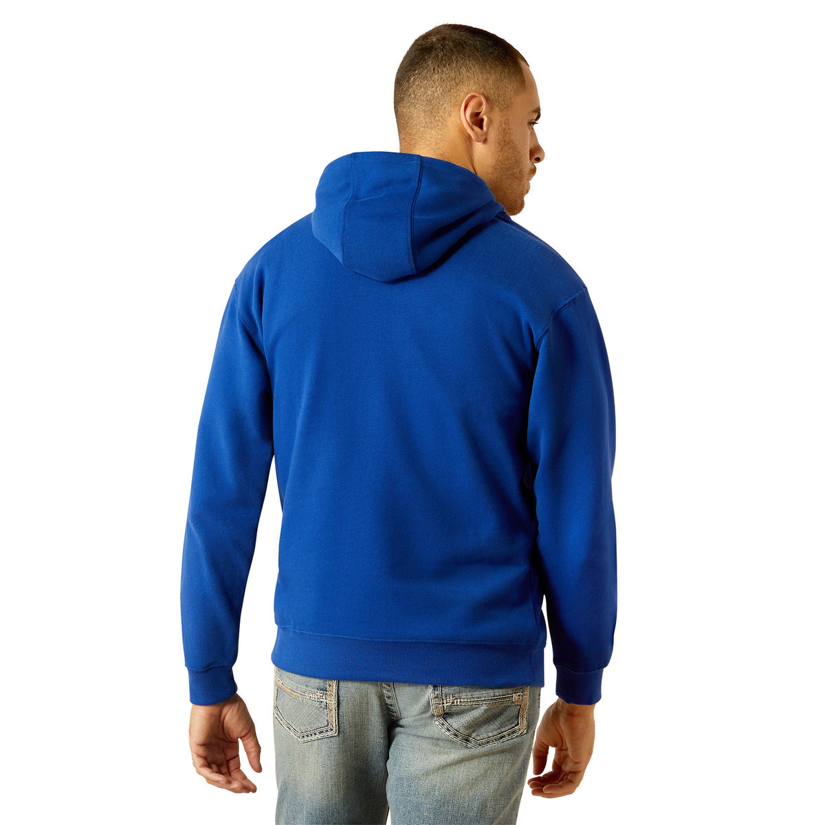 Back view of man wearing royal blue pullover hoodie with jeans, showing hood and cuffs