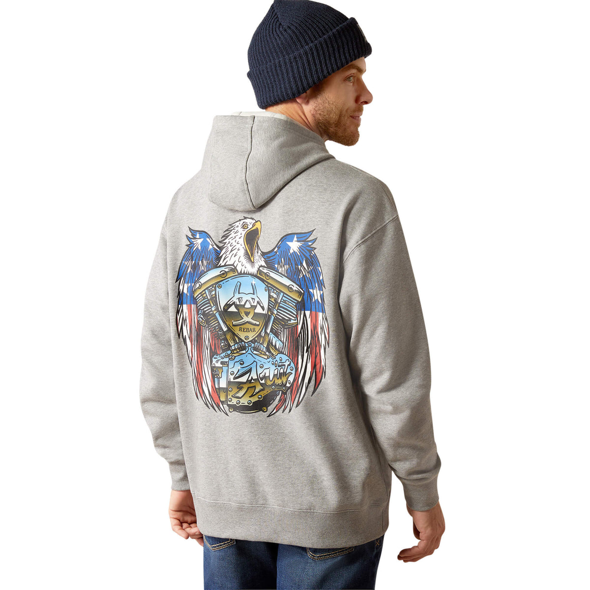 Man wearing grey pullover hoodie showing back graphic of eagle with American flag and motorcycle engine