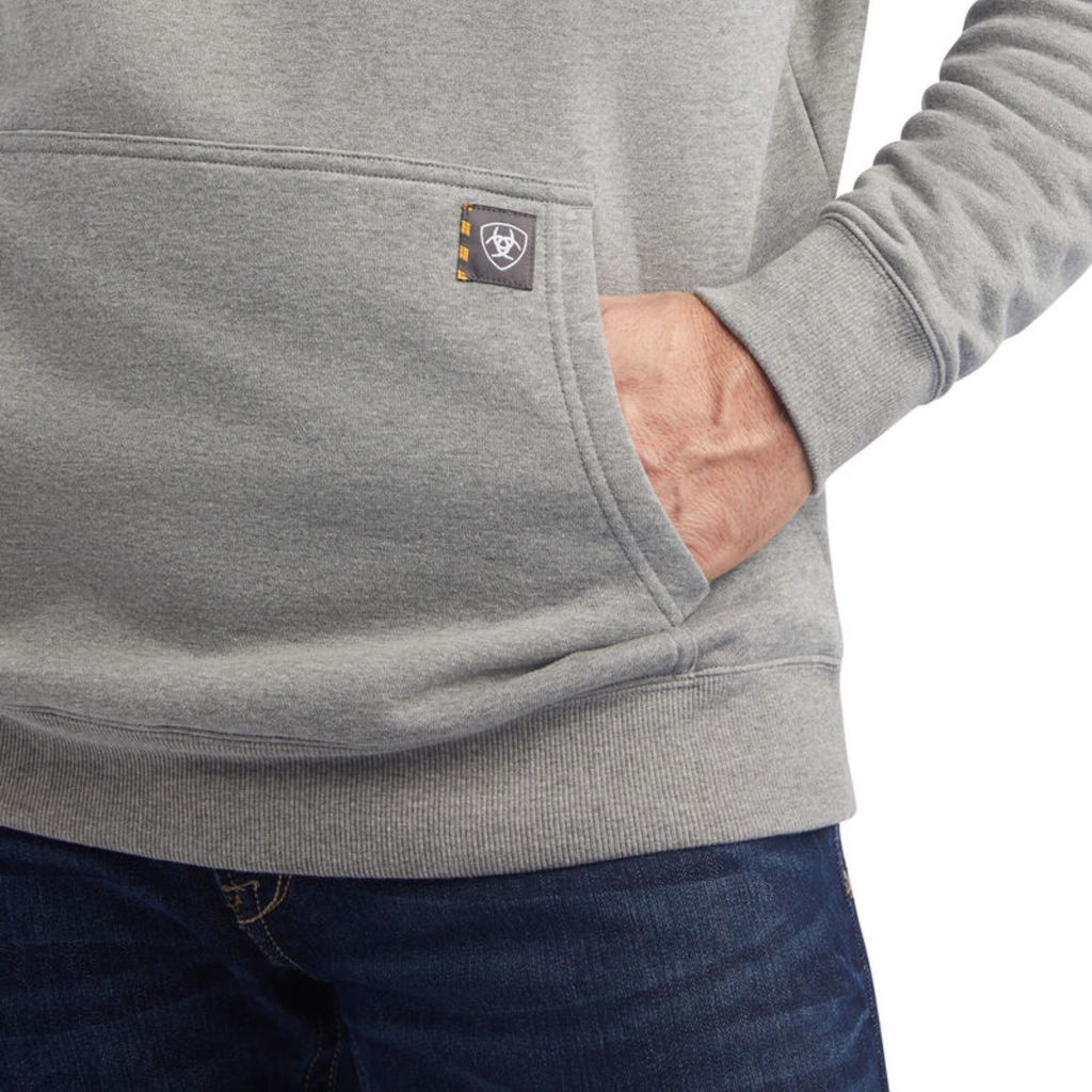 Close-up detail of Ariat men's grey hoodie kangaroo pocket with brand label patch