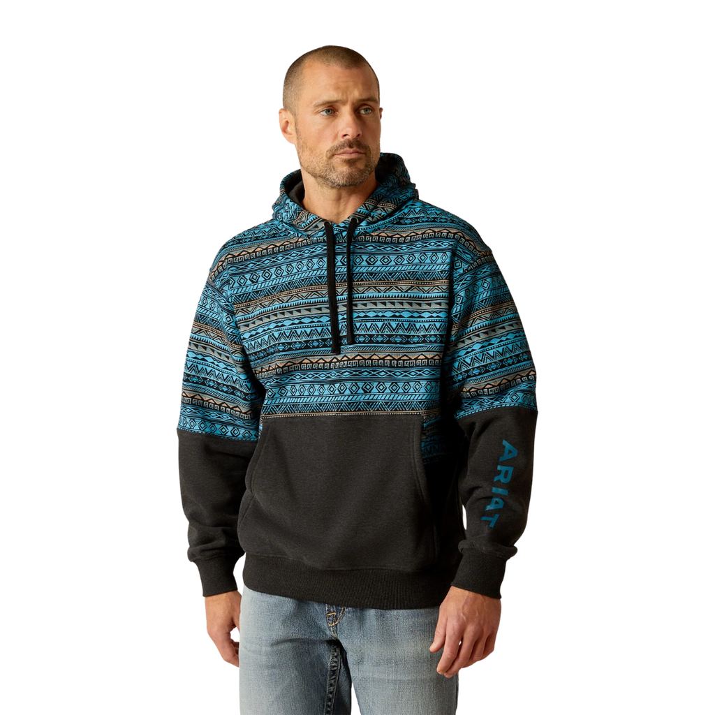Man wearing Ariat color block hoodie with Aztec print upper and black lower panel