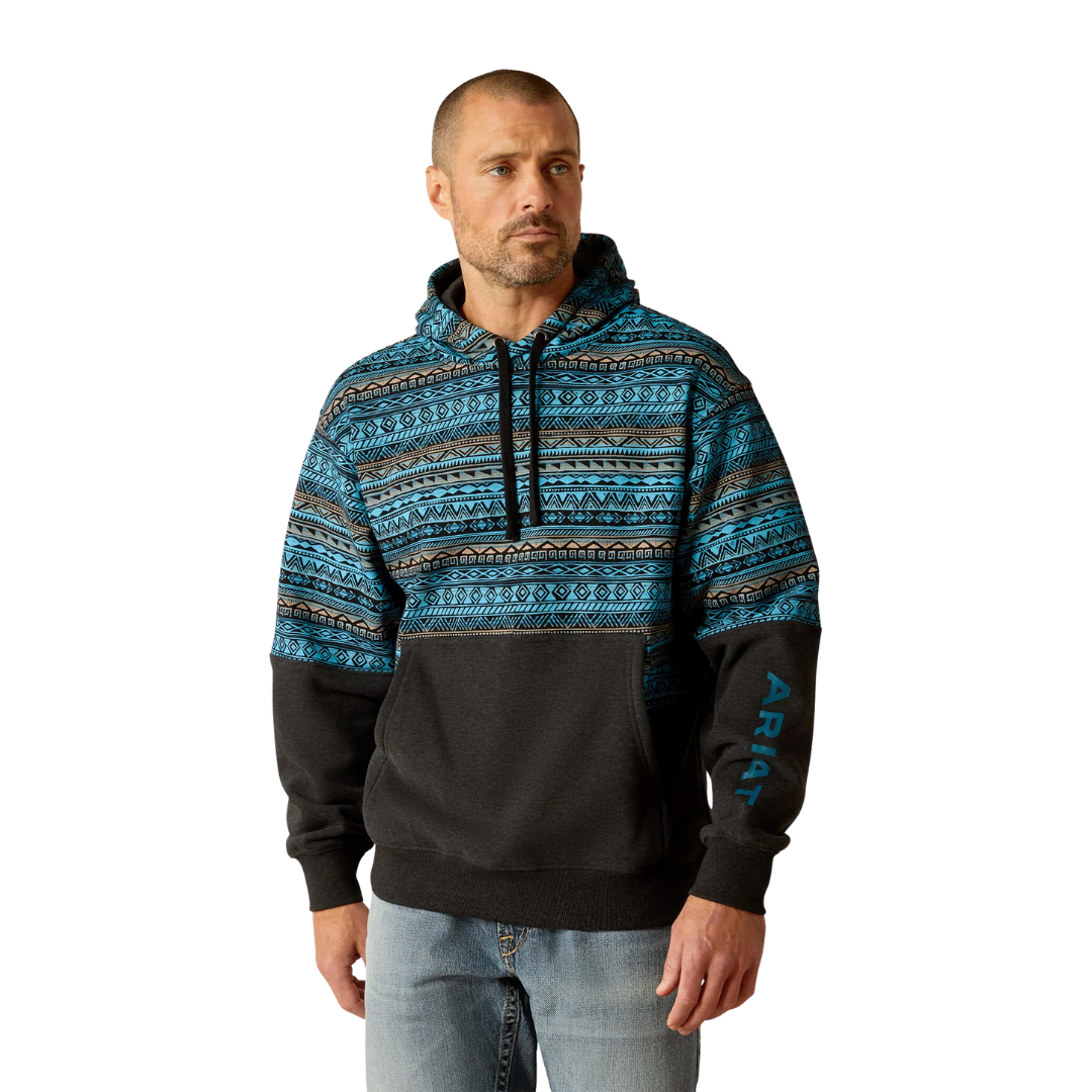 Man wearing Ariat color block hoodie with Aztec print upper and black lower panel