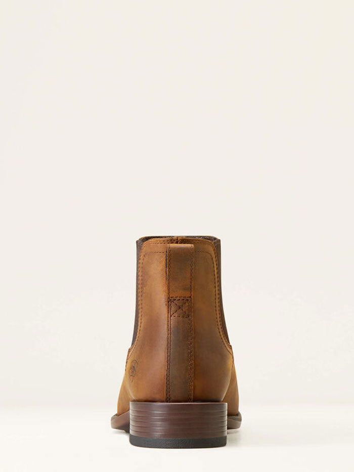 Rear view of a men's tan leather Chelsea boot with stacked heel and pull tab