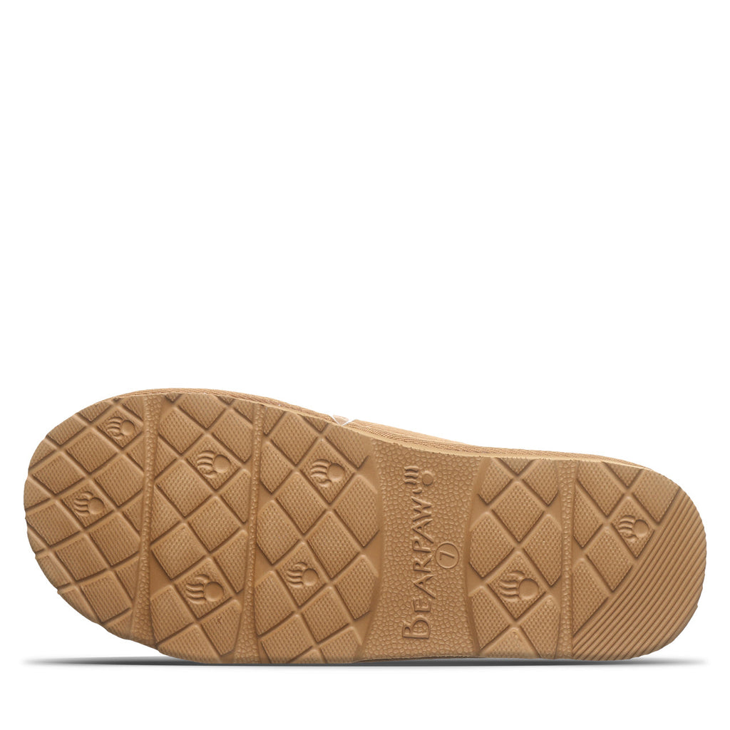 Bottom sole view of Bearpaw girls slip-on shoe showing textured rubber tread pattern with brand logo