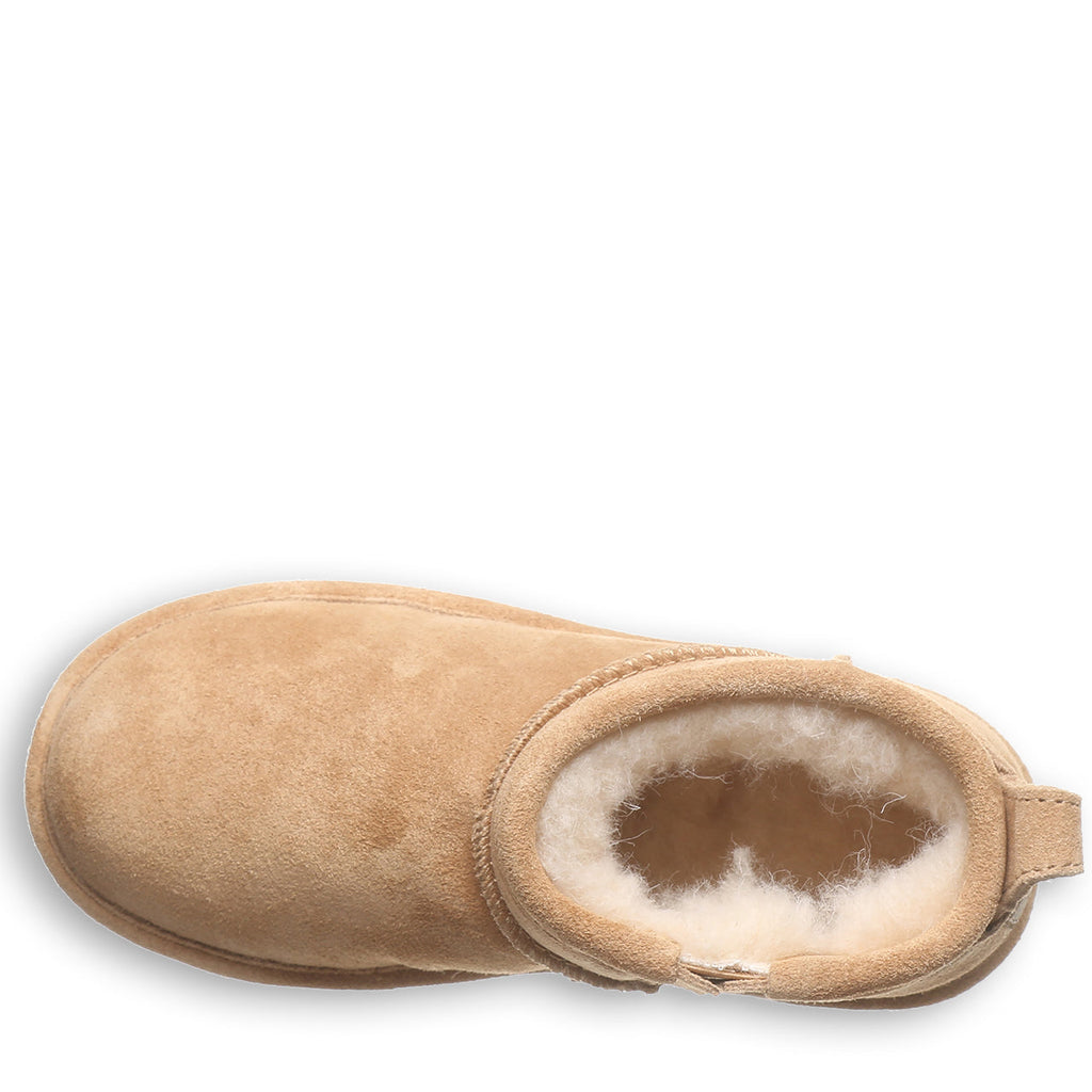 Top-down view of a short sheepskin boot with plush wool lining and suede upper