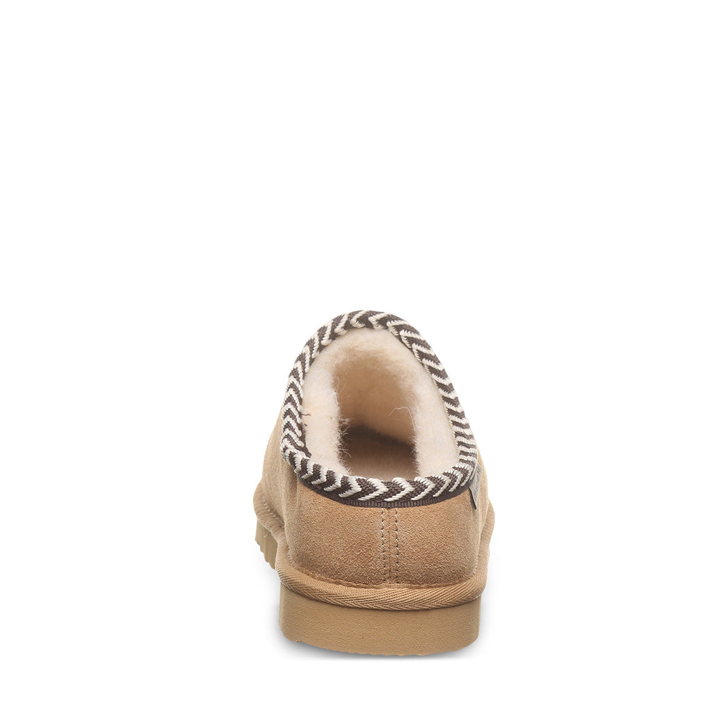 Back view of a suede slip-on slipper with sherpa lining and woven trim detail