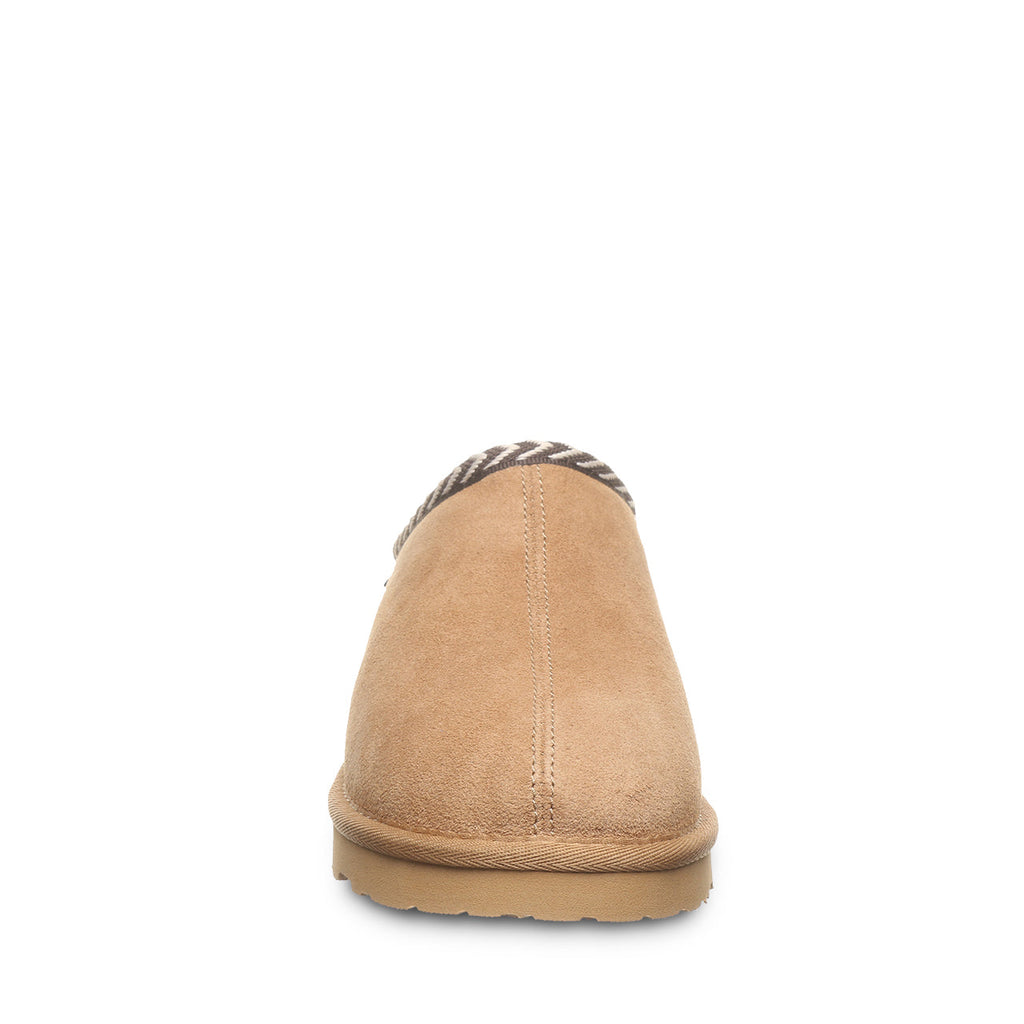 Back view of a tan suede slip-on slipper with chevron trim and rubber sole