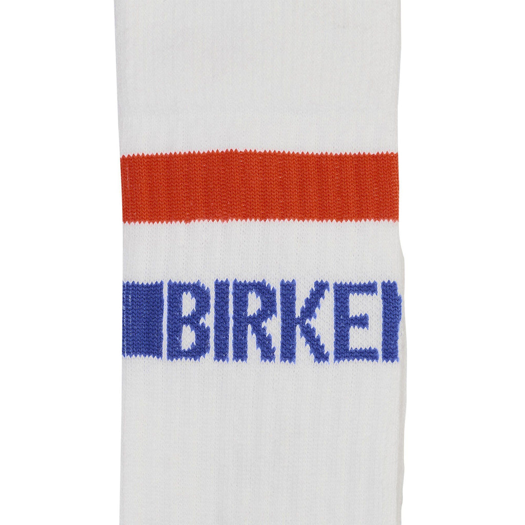 Close-up detail of white Birkenstock crew sock with red stripe and blue logo lettering