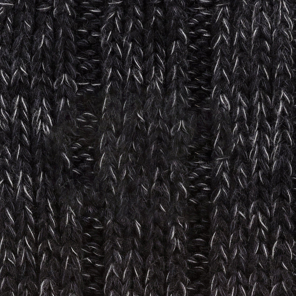 Close-up detail of black cotton twist knit textile showing ribbed weave texture and pattern