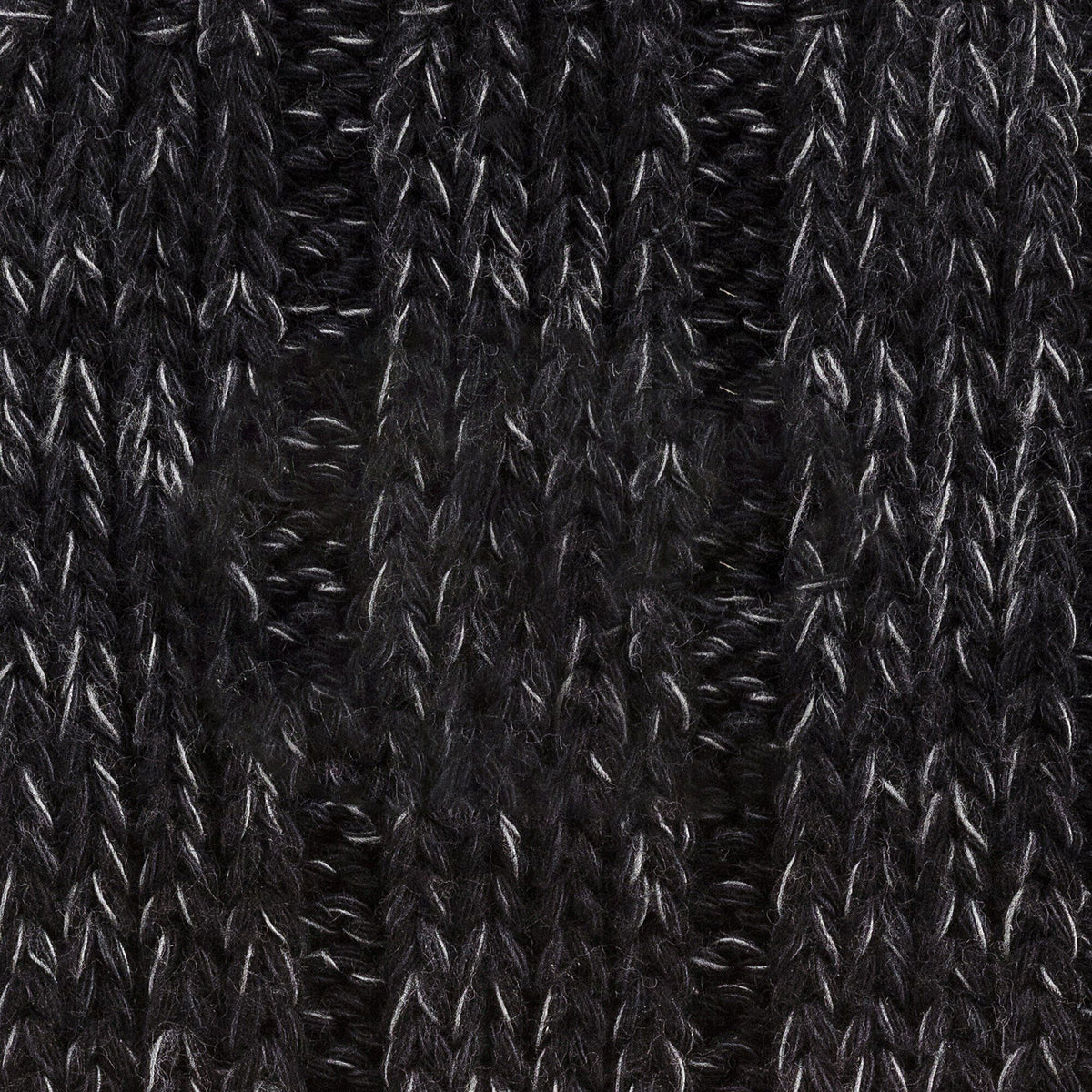 Close-up detail of black cotton twist knit textile showing ribbed weave texture and pattern