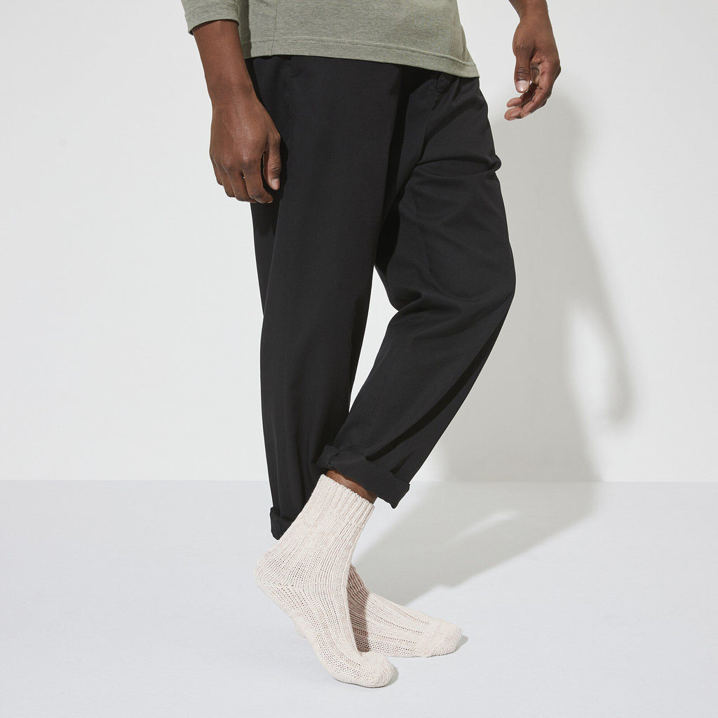 Model wearing off-white chunky knit Birkenstock cotton twist socks with black trousers