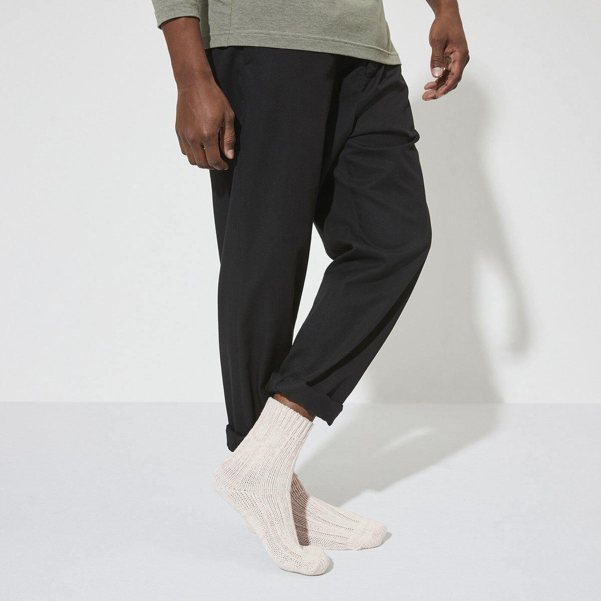 Model wearing off-white chunky knit Birkenstock cotton twist socks with black trousers