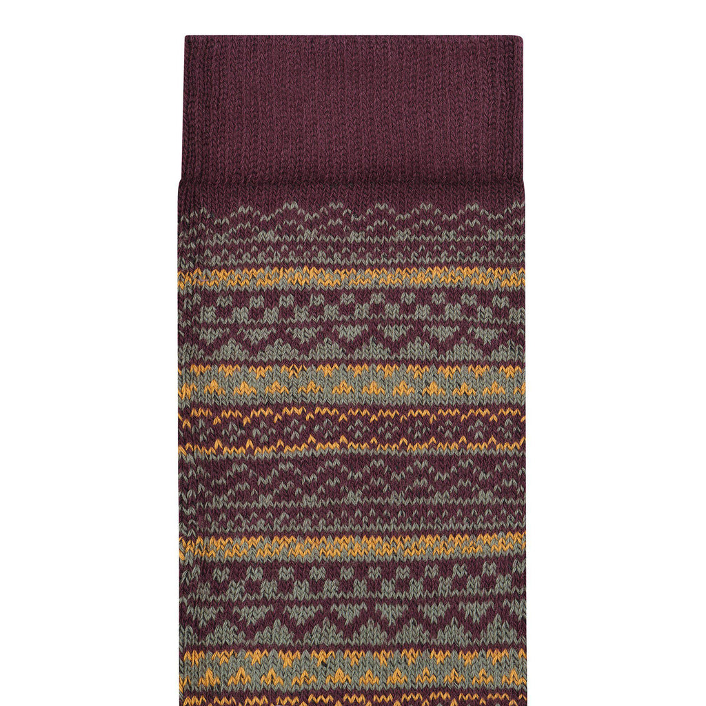Fair Isle patterned knit sock with folded cuff showing geometric stripe detail