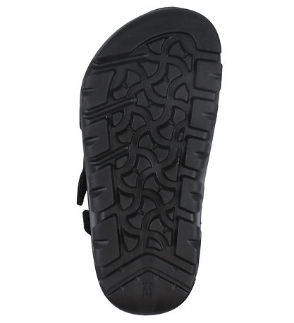 Bottom sole view of a kids Birkenstock sandal showing textured black EVA outsole with hook and loop strap