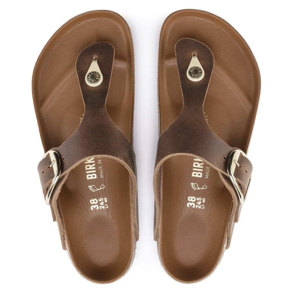 Birkenstock Gizeh thong sandals with large gold buckle, top-down view showing both sandals