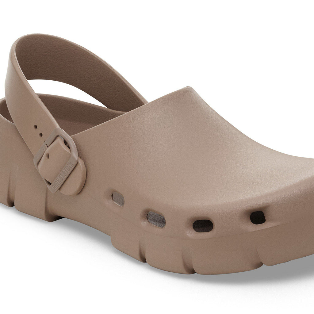Birkenstock slingback clog with buckle strap, ventilation holes, and chunky outsole
