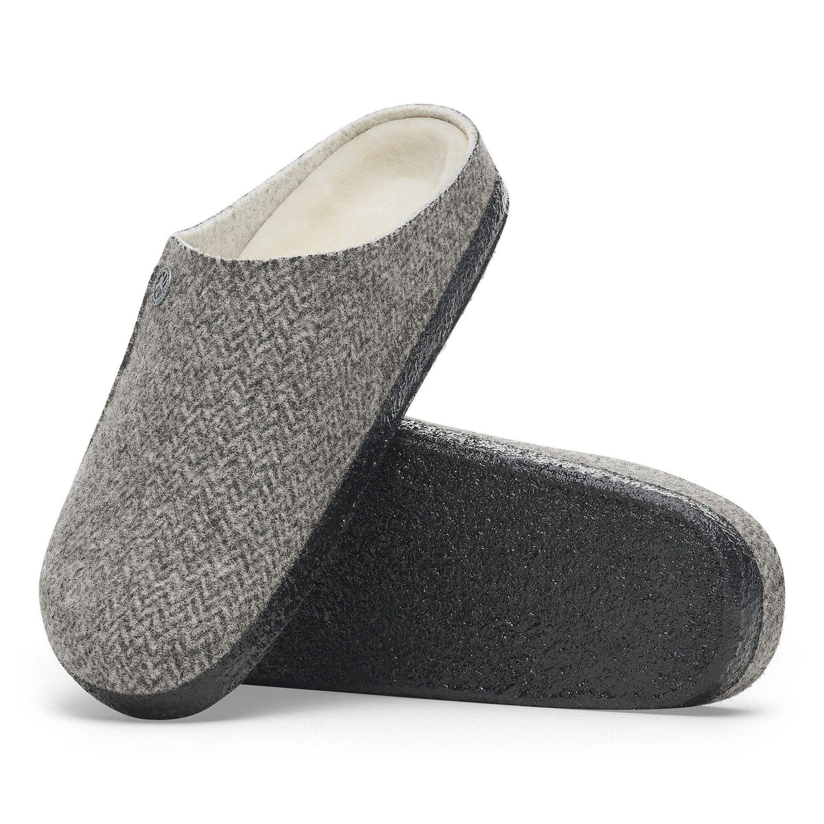 Pair of gray herringbone clog slippers with cream shearling lining and dark rubber sole