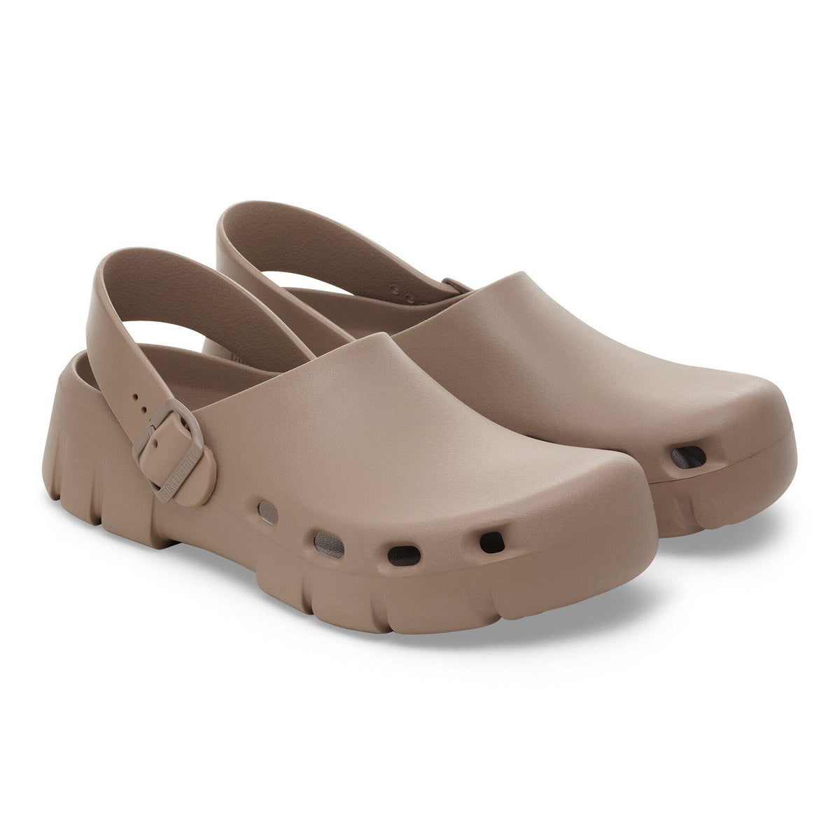 Pair of taupe slingback clogs with buckle strap and chunky textured sole