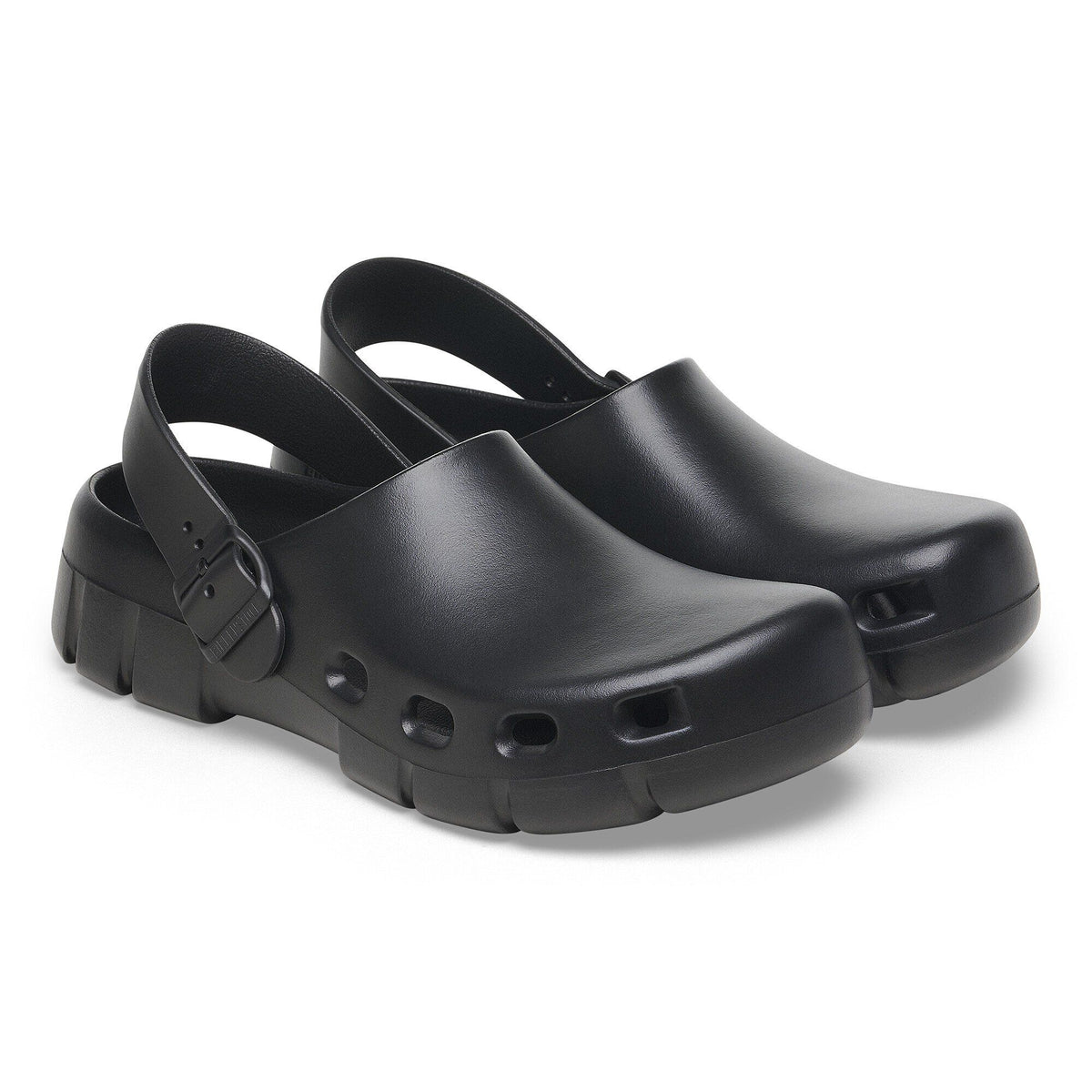 Pair of Birkenstock slingback clogs with buckle strap and ventilation holes on sole