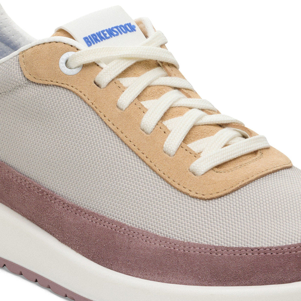 Birkenstock Honnef sneaker close-up showing canvas upper, tan suede overlays, and white laces