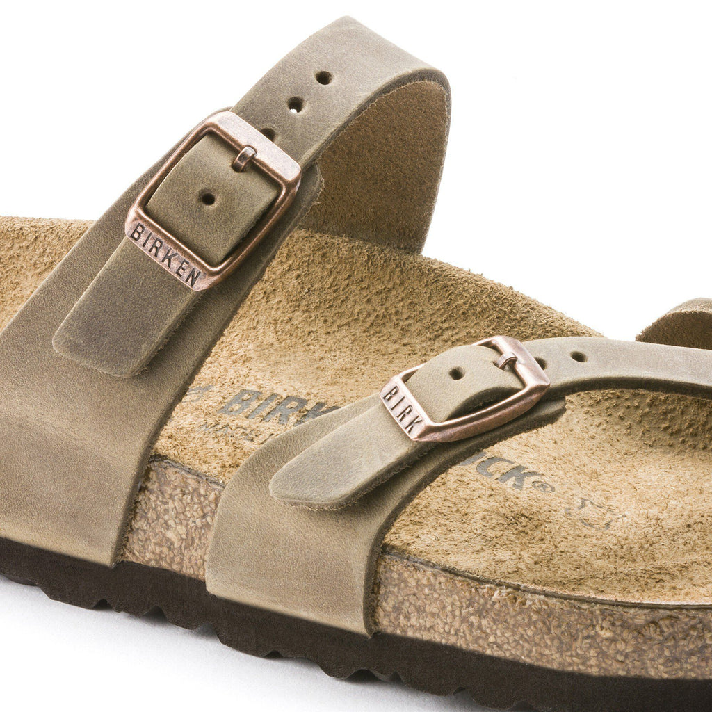 Close-up detail of Birkenstock Mayari sandal showing oiled leather straps and copper buckles