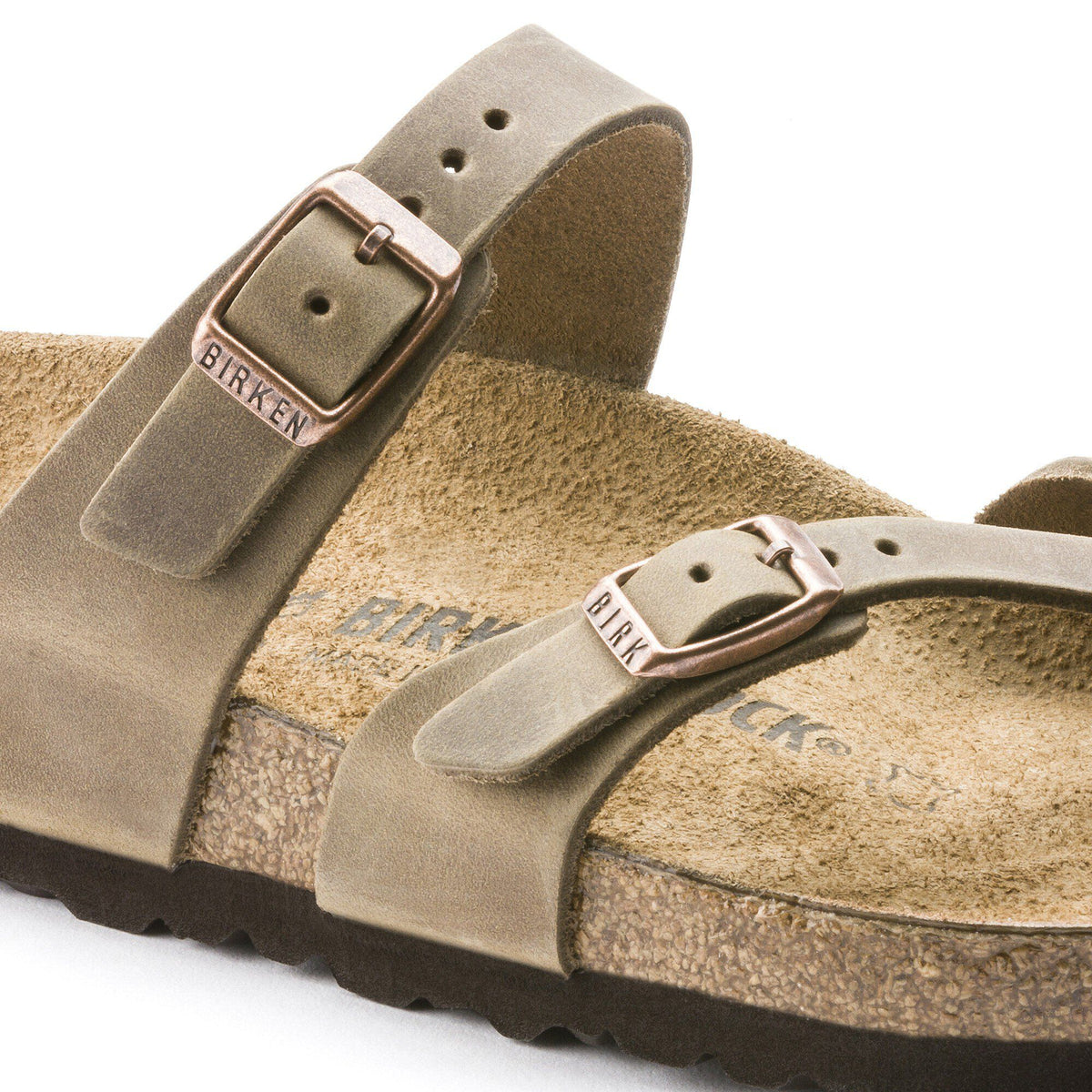 Close-up detail of Birkenstock Mayari sandal showing oiled leather straps and copper buckles