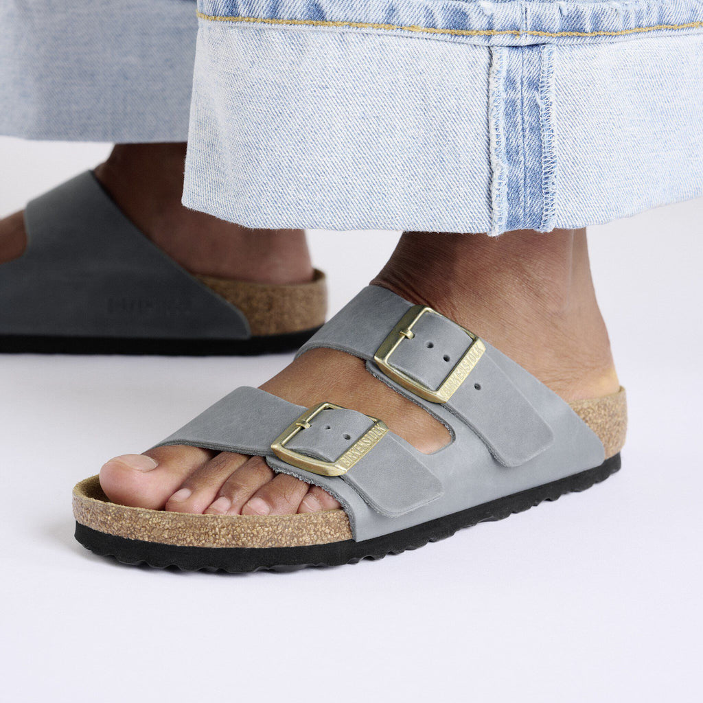 Birkenstock Arizona two-strap sandals with gold buckles worn with light denim skirt