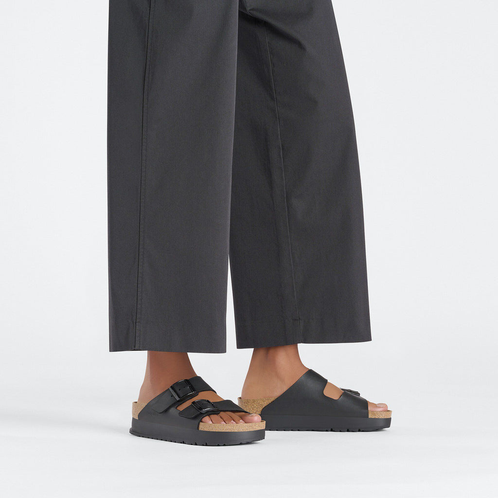 Model wearing Birkenstock Arizona Platform sandals with cork footbed and double buckle straps