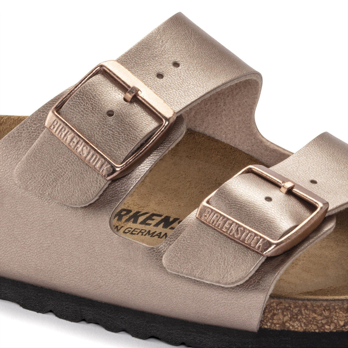 Close-up detail of Birkenstock Arizona sandal showing two adjustable buckle straps and cork footbed
