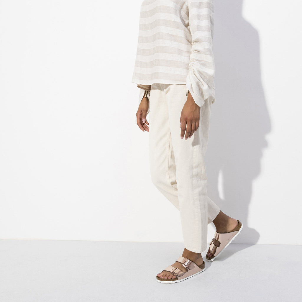 Model wearing Birkenstock Arizona sandals with double buckle straps and contoured footbed