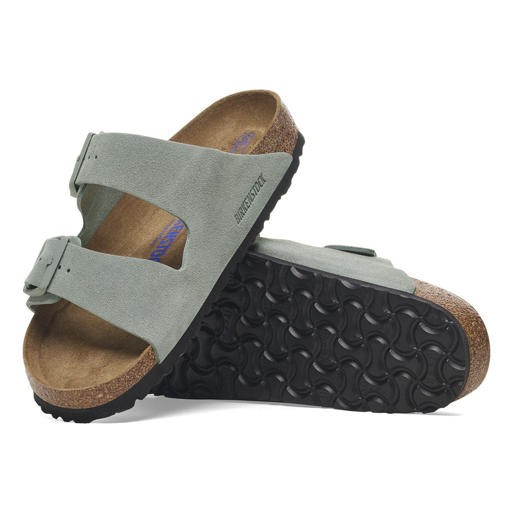 Birkenstock Arizona suede sandals shown from side and bottom angles displaying cork footbed and rubber sole