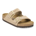 Birkenstock Arizona two-strap sandal with gold buckles and cork footbed on white background