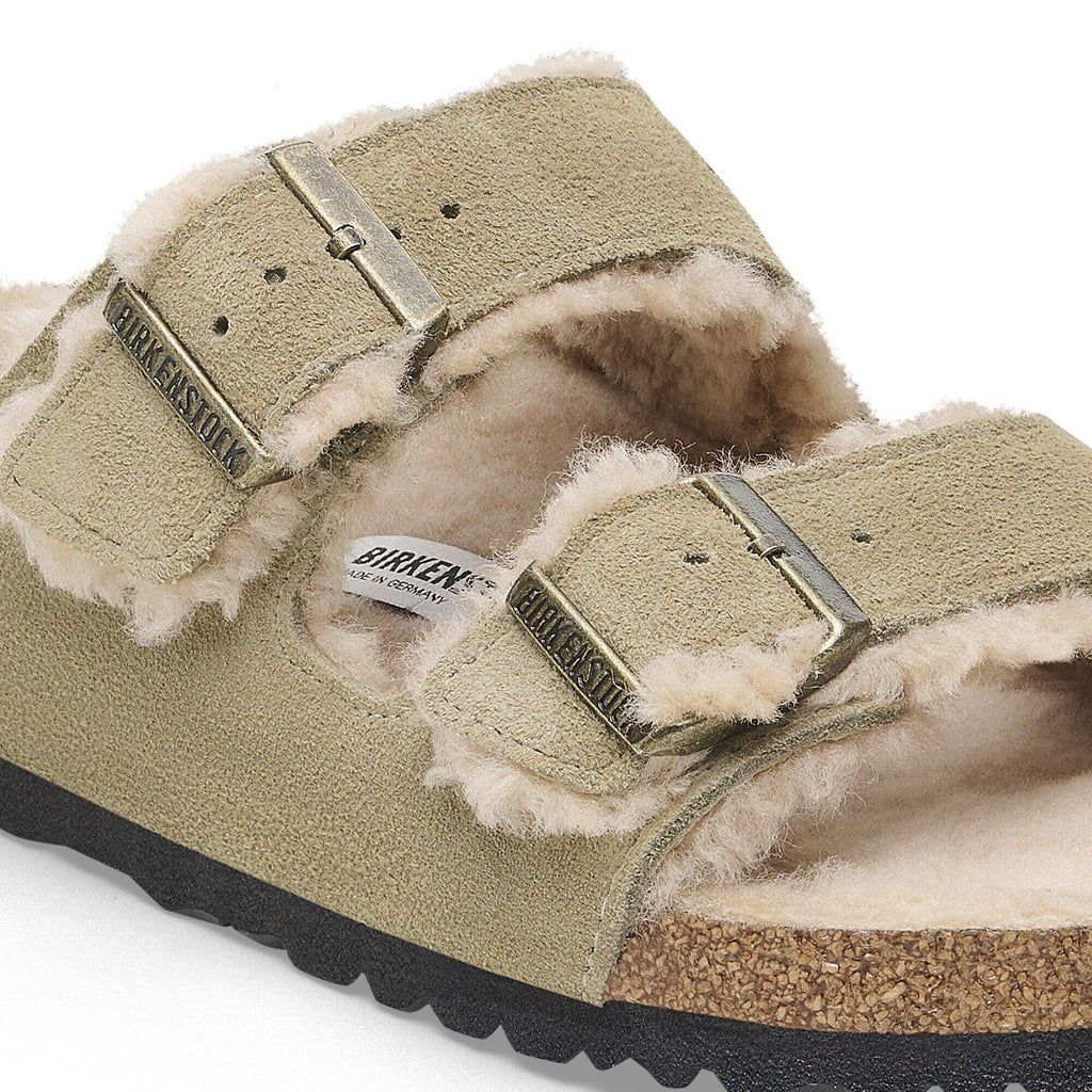 Birkenstock Arizona Shearling sandal detail showing suede straps, shearling lining, and gold buckles
