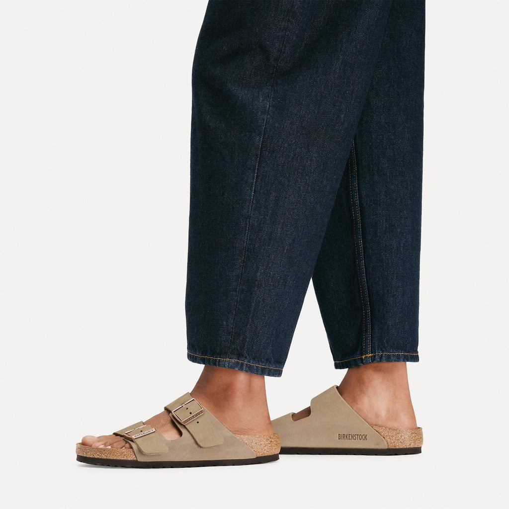 Birkenstock Arizona two-strap sandals worn with dark cropped denim jeans on model