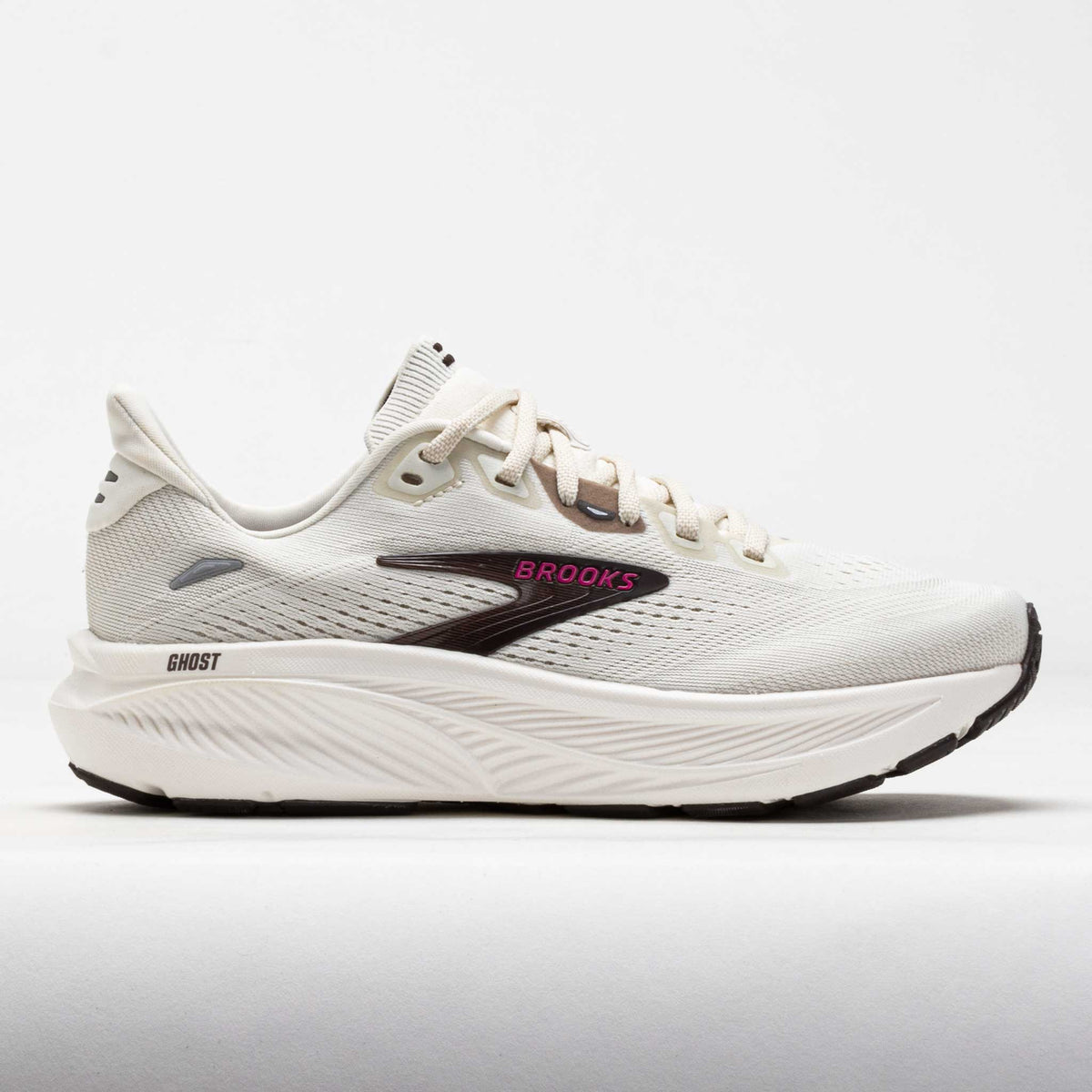 Brooks Ghost running shoe in off-white with black logo and pink brand lettering, lateral view