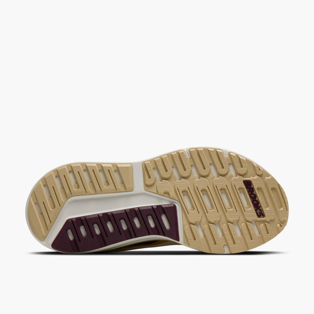 Bottom sole view of Brooks running shoe showing tan rubber outsole with purple heel cushioning