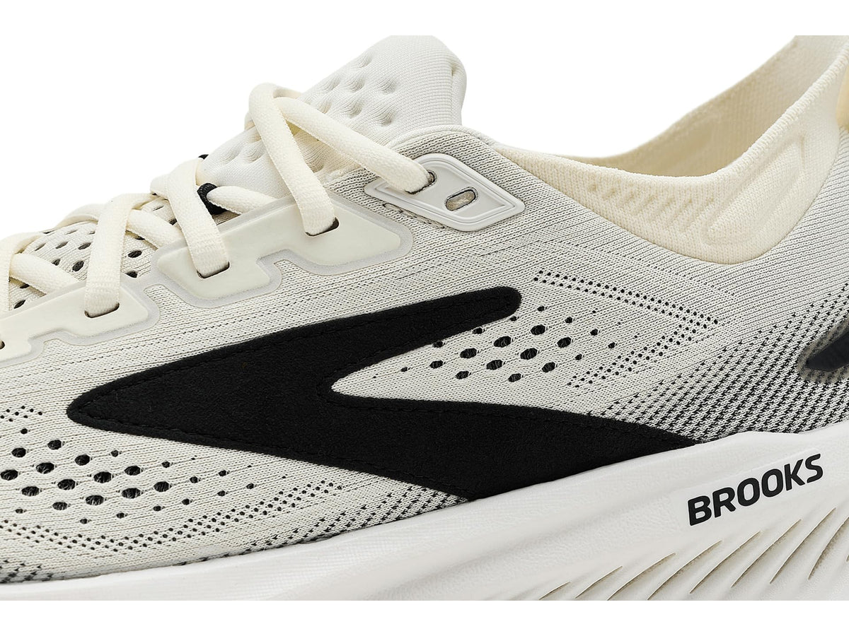 Close-up detail of Brooks running shoe upper showing brand logo and knit mesh construction