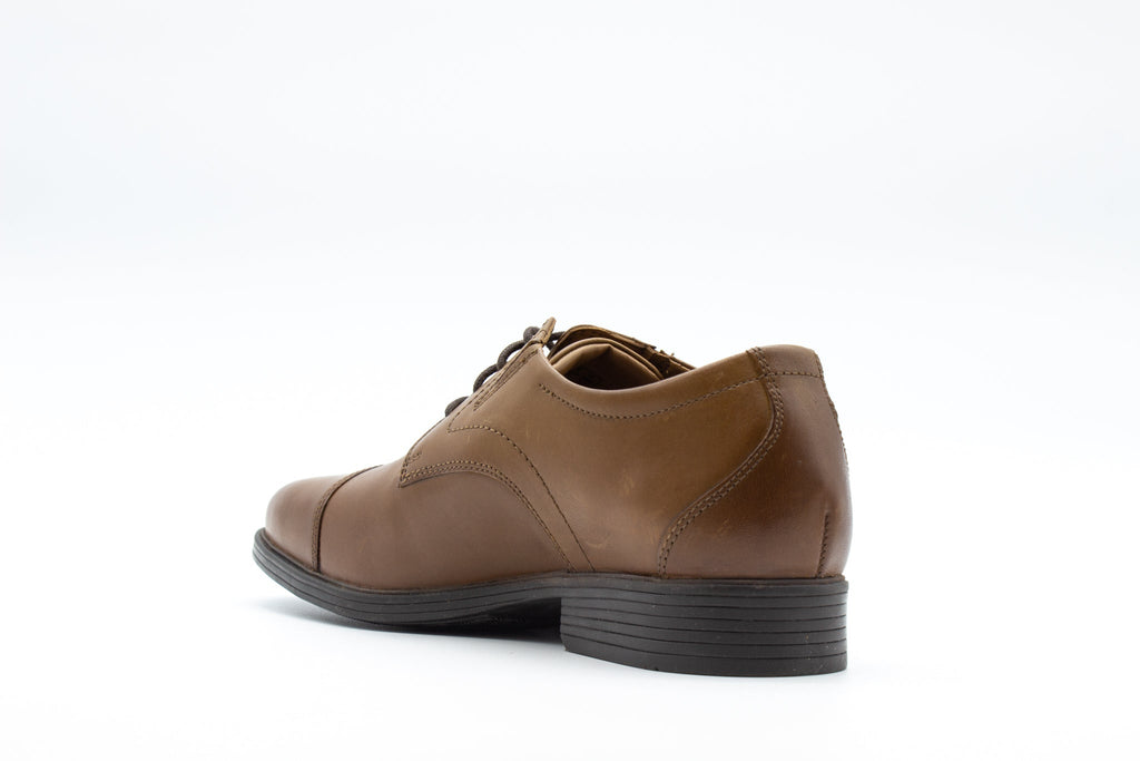 Men's leather cap-toe Oxford dress shoe shown from rear three-quarter angle on white background