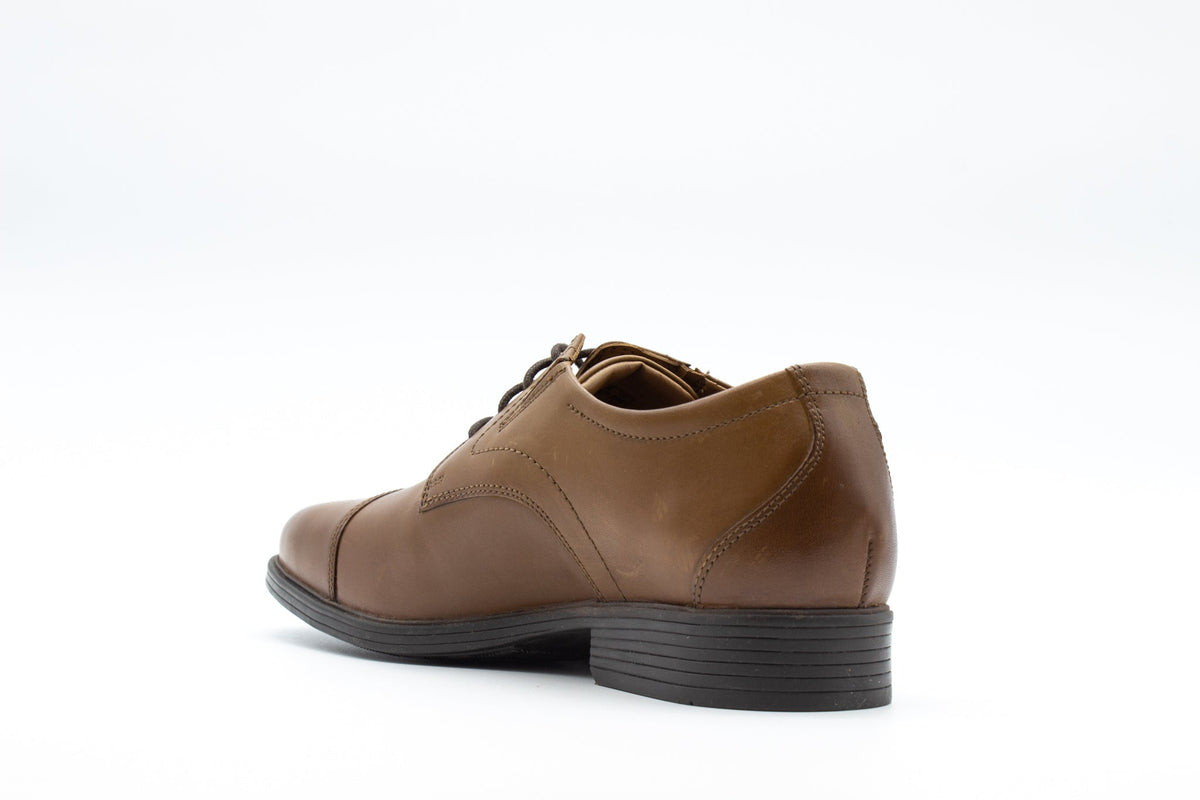 Men's leather cap-toe Oxford dress shoe shown from rear three-quarter angle on white background