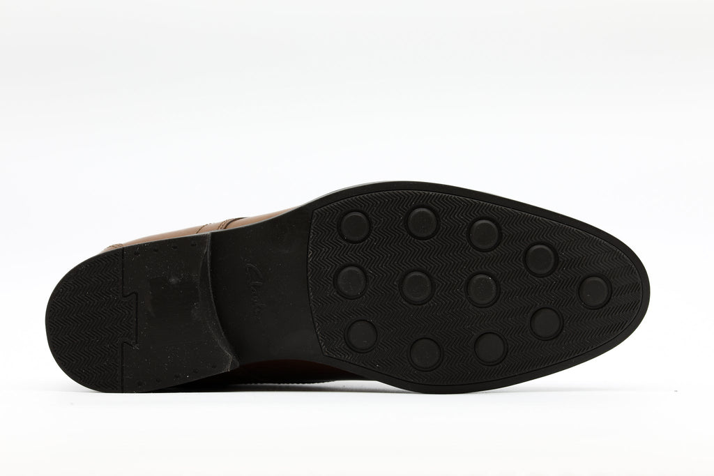 Bottom sole view of a Clarks men's leather dress shoe showing rubber tread pattern