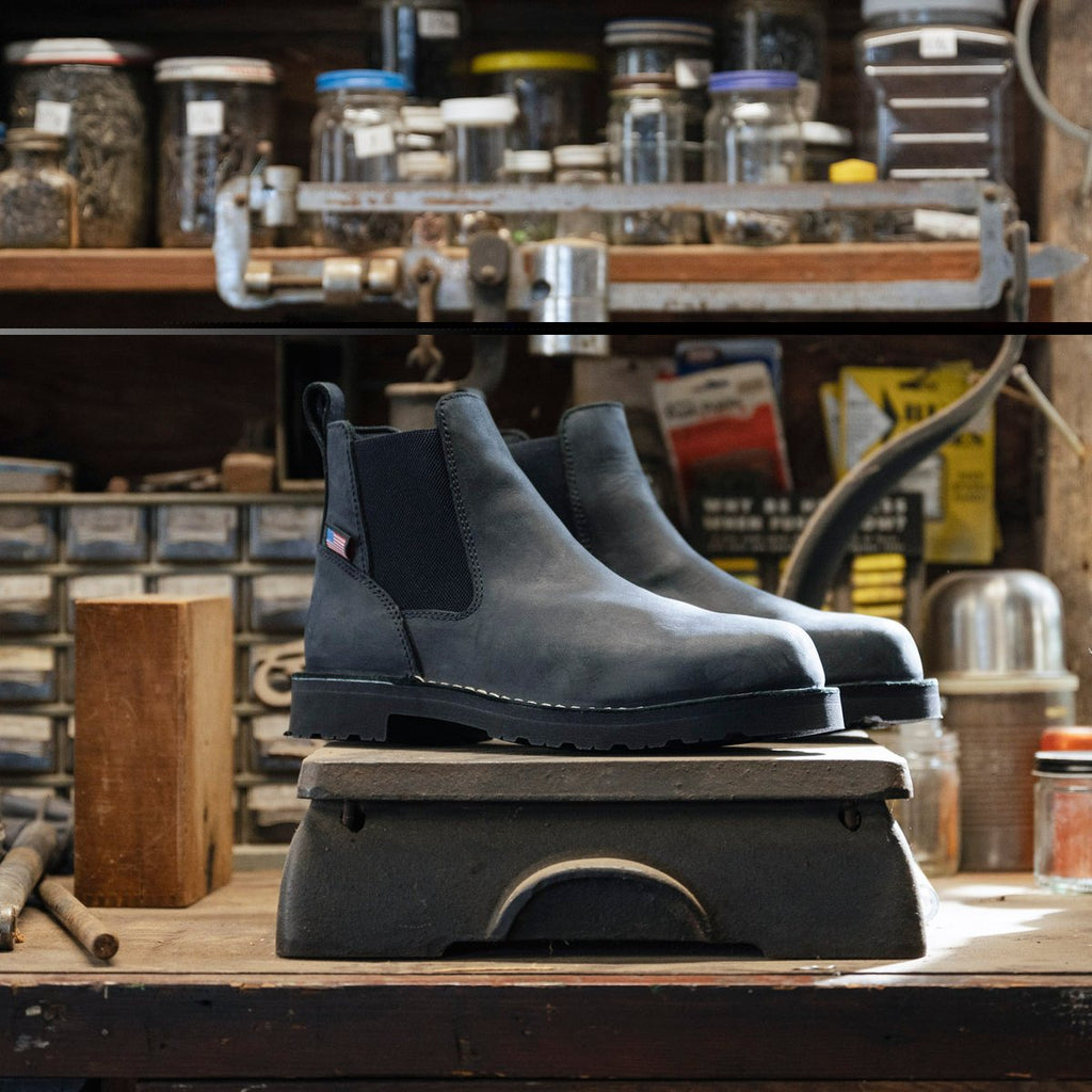 Danner mens Chelsea ankle boot with elastic side panels displayed on vintage workshop platform