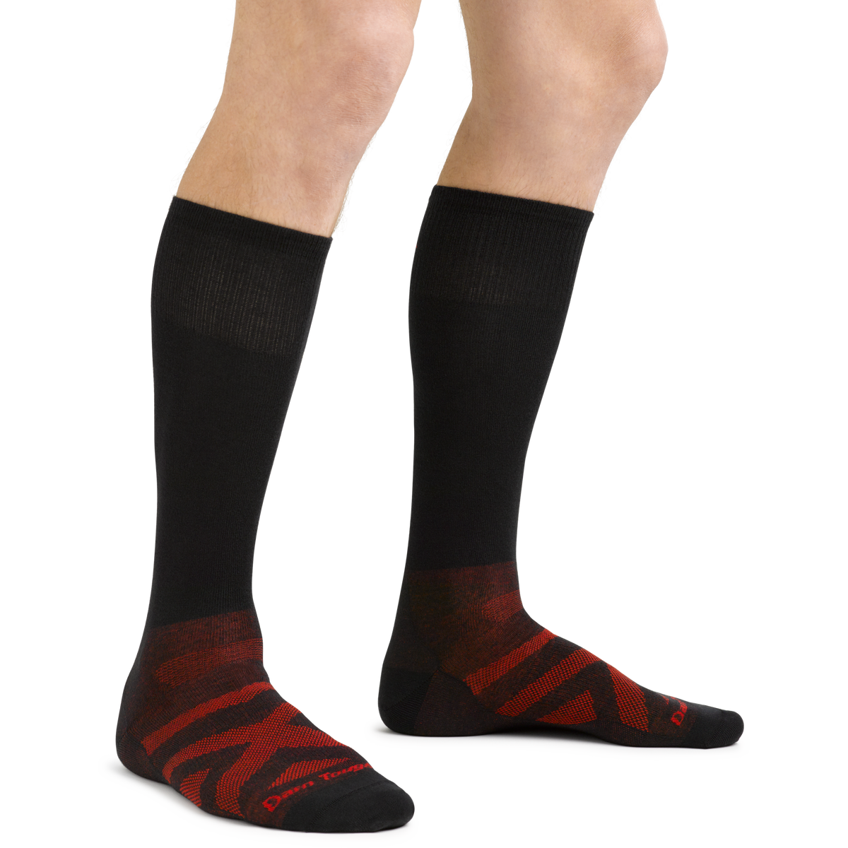Model wearing knee-high black compression socks with red patterned foot detail, standing upright