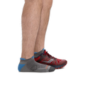 Men's gray no-show tab running sock worn with red trail running shoe, side view
