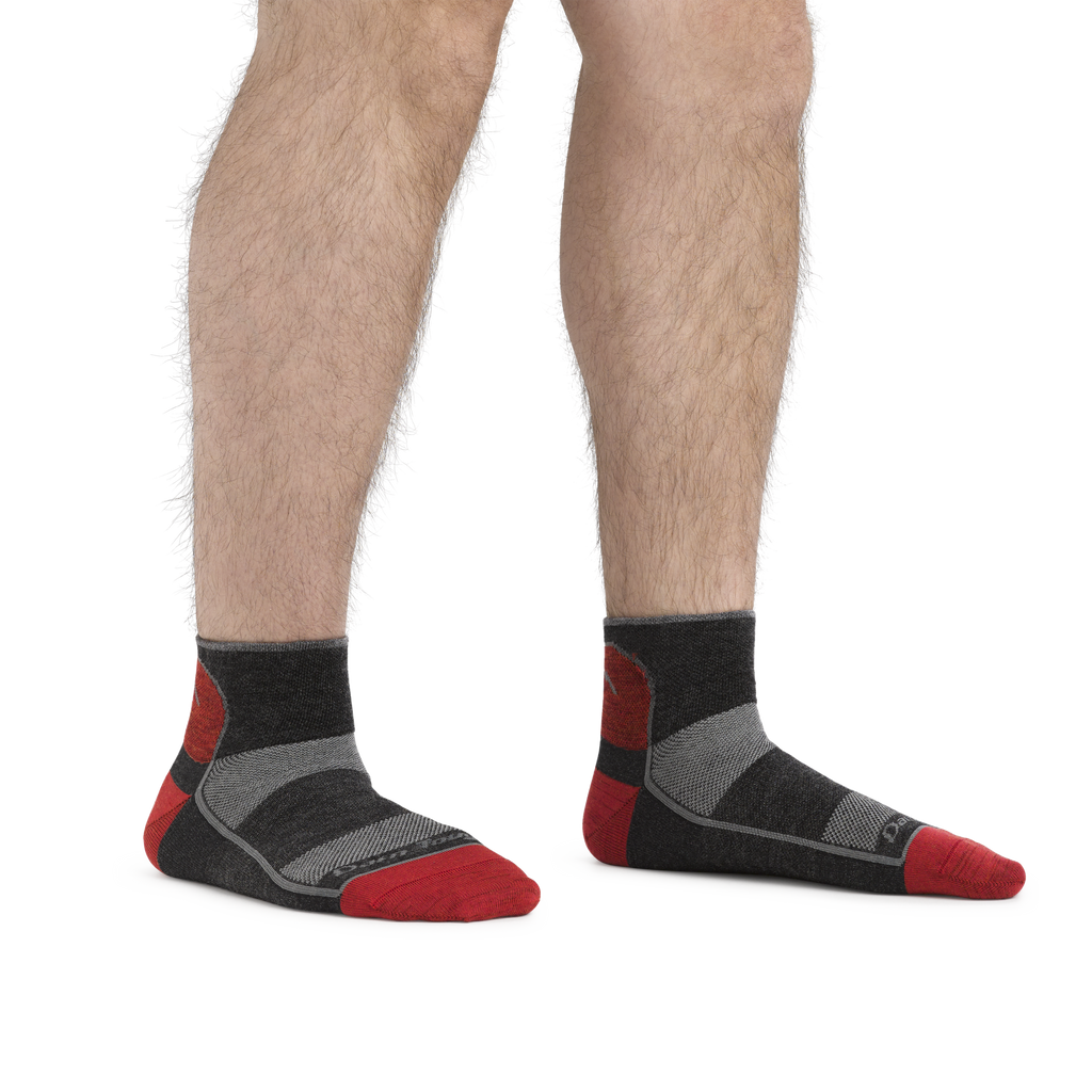Man wearing Darn Tough quarter-length cushioned socks with red toe and heel accents