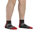 Man wearing Darn Tough quarter-length cushioned socks with red toe and heel accents