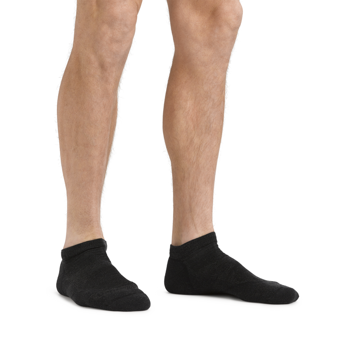 Male model wearing black no-show ankle socks displayed against white background