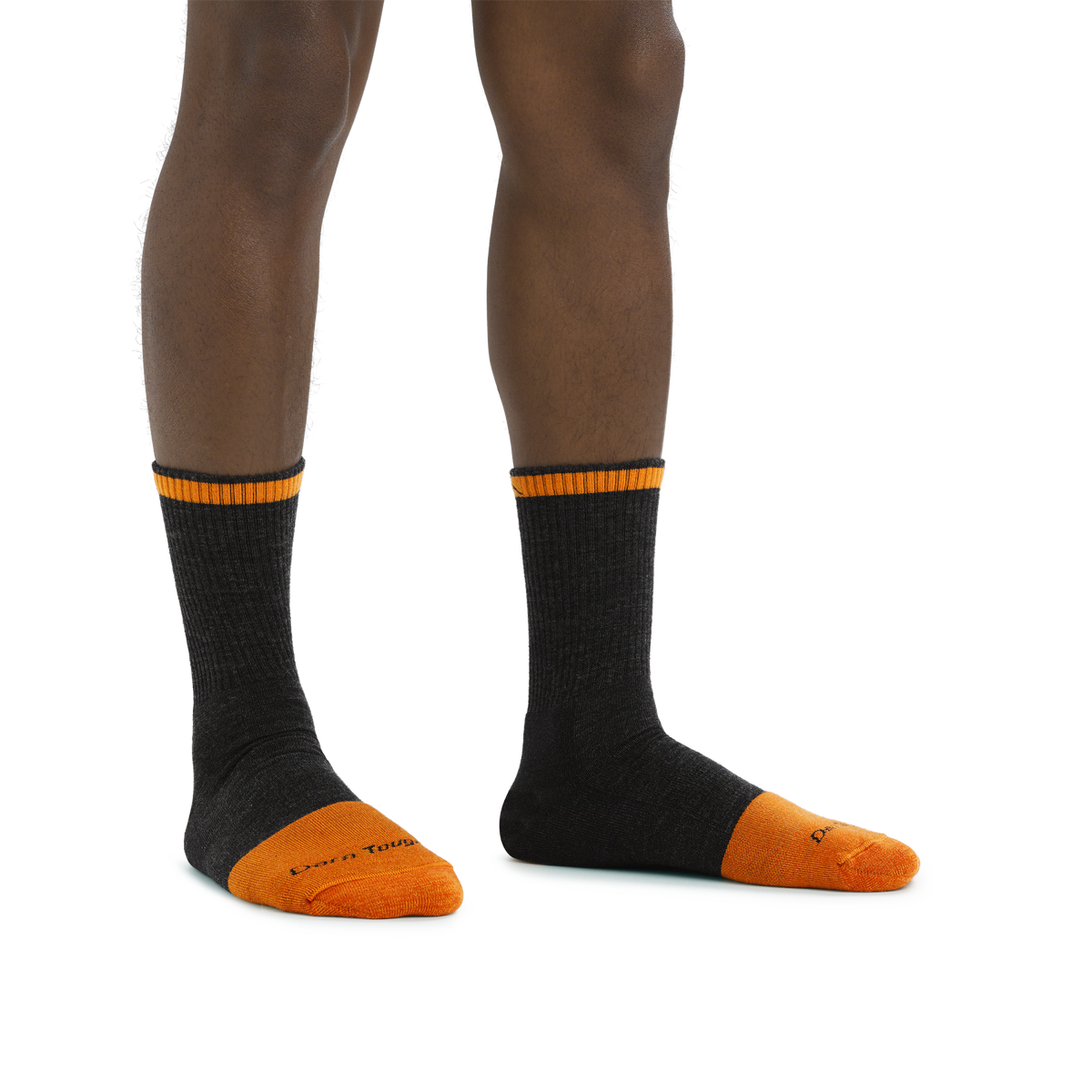 Model wearing Darn Tough micro crew socks with reinforced orange toe and cuff stripe